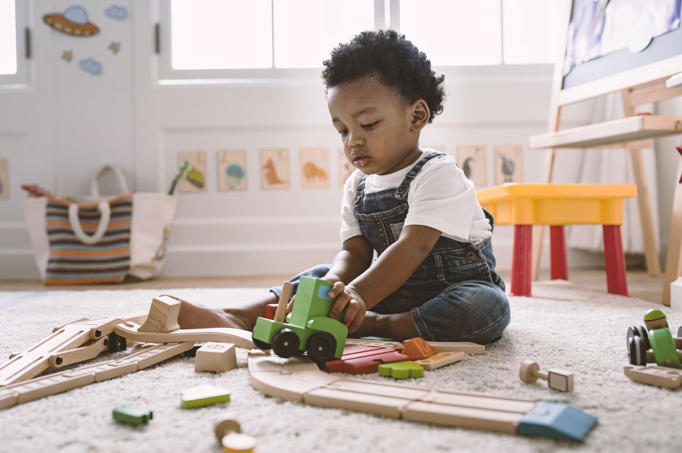 Kid playing with wooden toys